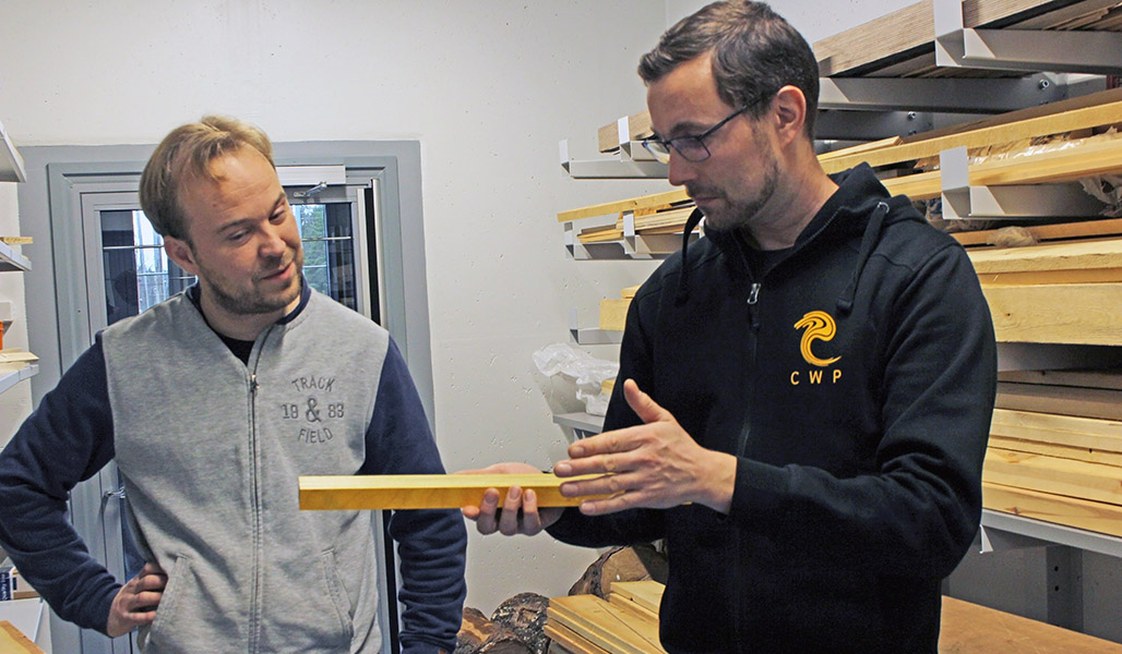Villeveikko Tuikkanen och Jussi Helve studerar en träbit i slöjdsalens förråd.